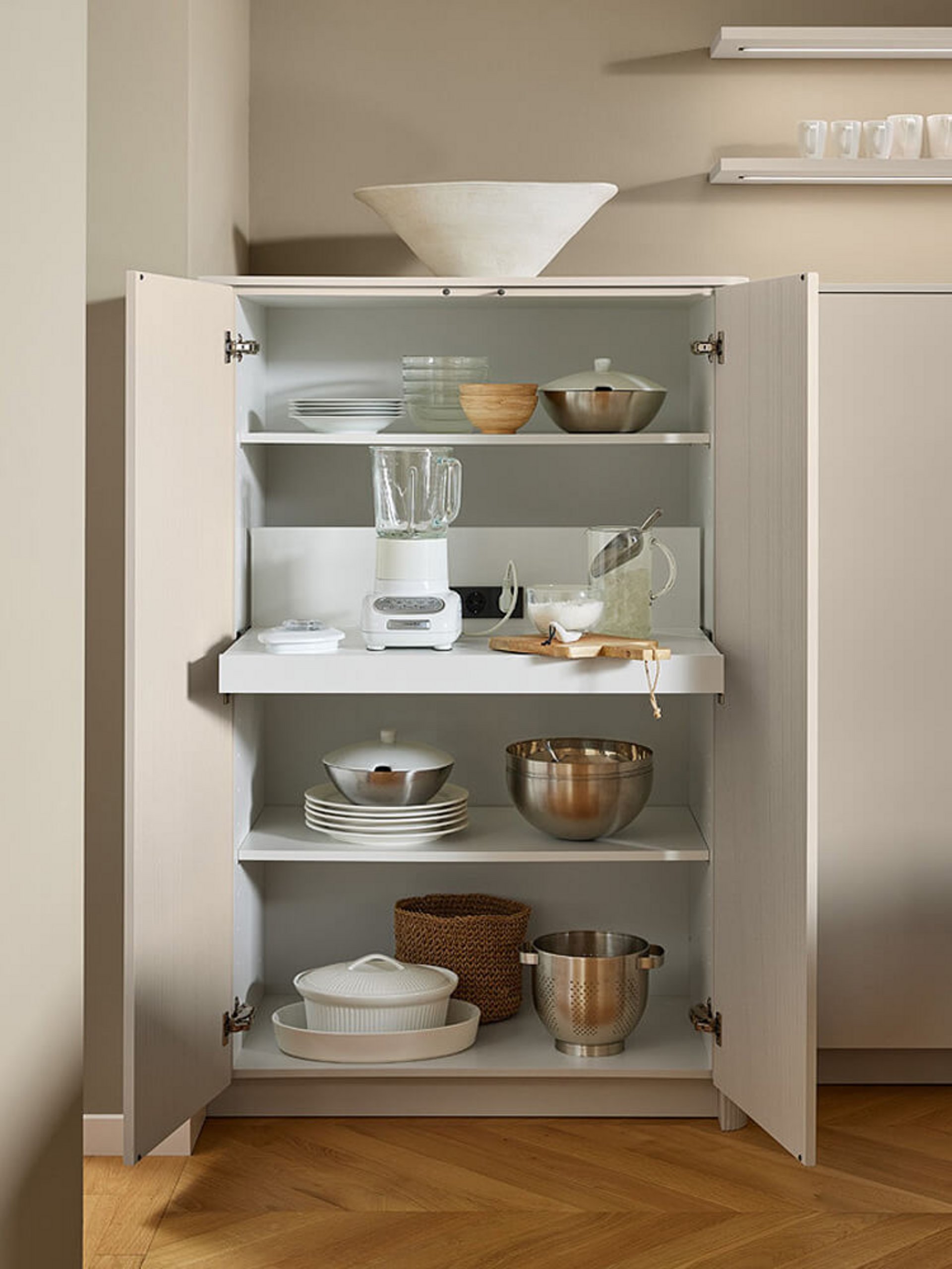 Funktionale Küchenausstattung mit ausziehbarem Tablarboden für Küchengeräte im Vorratsschrank.